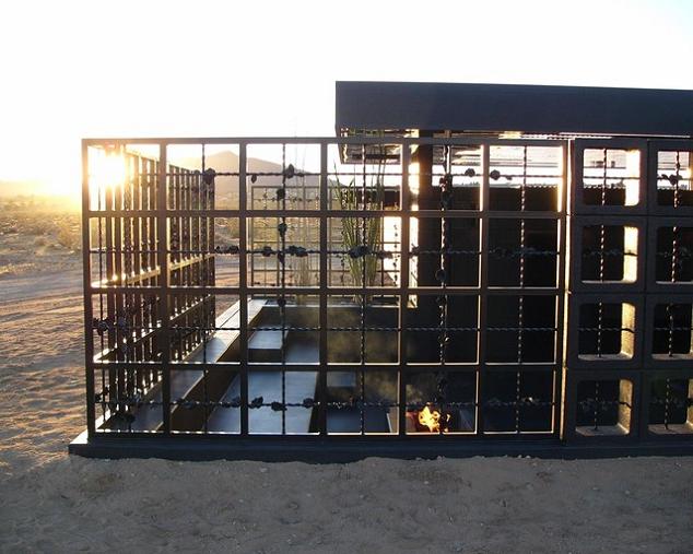 open concept desert hotel room all black What Happens When a Punk Rocker Designs a Desert Home?
