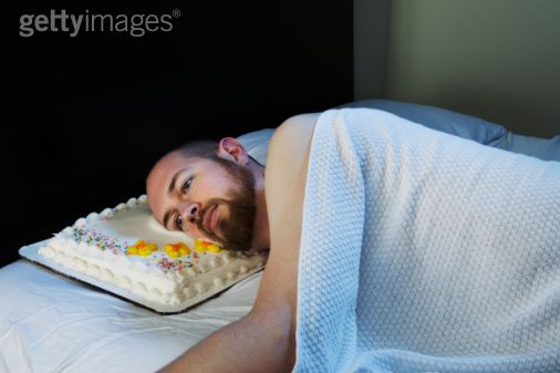 man laying in bed with cake pillow The Friday Shirk Report   October 1, 2010 | Volume 77