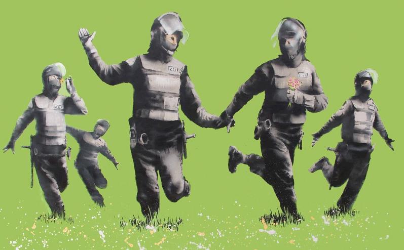 riot cops playing in field Picture of the Day: Banksys Green Riot Cops