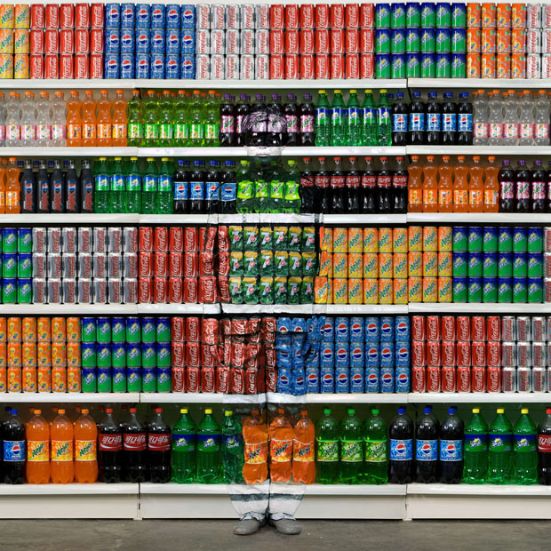 liu bolin see through camouflage store shelf Picture of the Day: Retail Camouflage