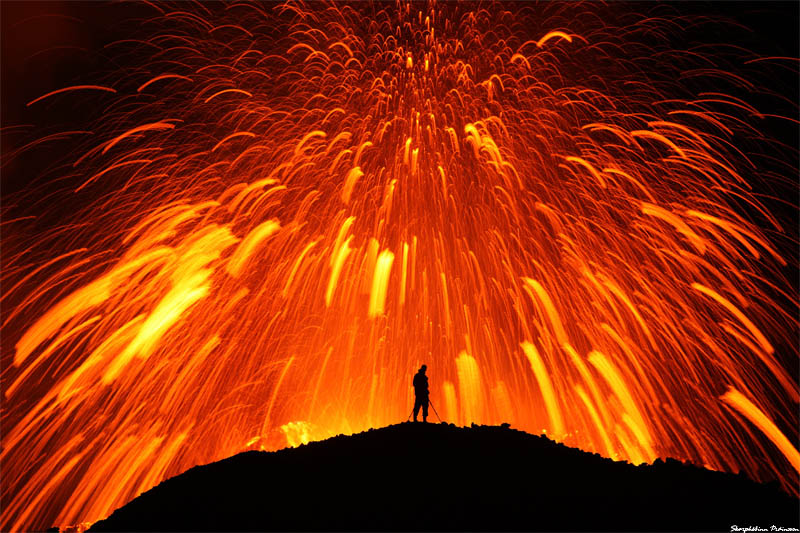 standing in front of erupting volcano Picture of the Day: Playing with Fire