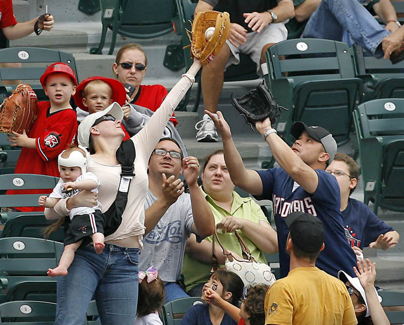 super mom catching baseball holding baby Picture of the Day: Super Mom!