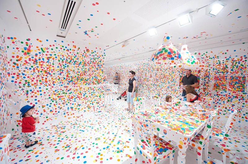 white room covered in stickers by kids yayoi kusama obliteration room 10 Artist Covers Car in Chalkboard Paint, Lets People Draw On It