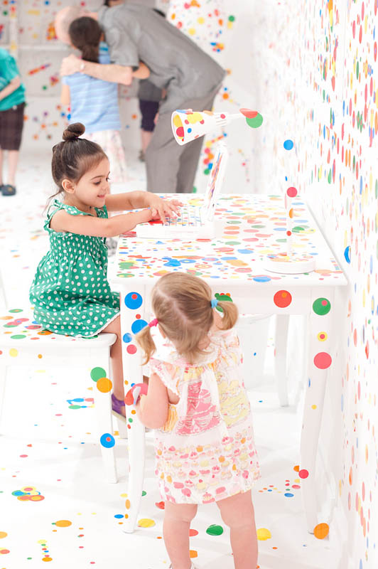white room covered in stickers by kids yayoi kusama obliteration room 6 Kids Turn White Room into Explosion of Color