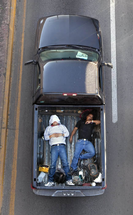 aerial birds eye view of people riding car pooling in back of pickup trucks from above alejandro cartagena 2 Riding in the Back of Pickup Trucks   A Birds Eye View