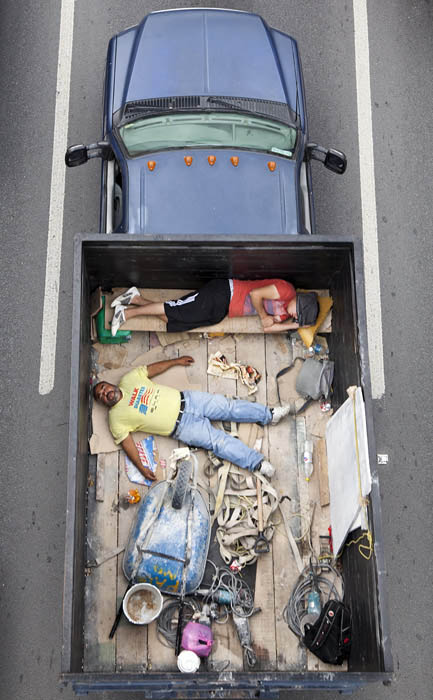 aerial birds eye view of people riding car pooling in back of pickup trucks from above alejandro cartagena 3 Cramped Hong Kong Apartments from Above