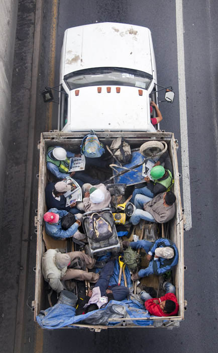 aerial birds eye view of people riding car pooling in back of pickup trucks from above alejandro cartagena 4 Riding in the Back of Pickup Trucks   A Birds Eye View