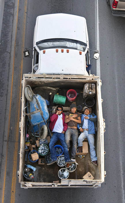 aerial birds eye view of people riding car pooling in back of pickup trucks from above alejandro cartagena 5 Riding in the Back of Pickup Trucks   A Birds Eye View