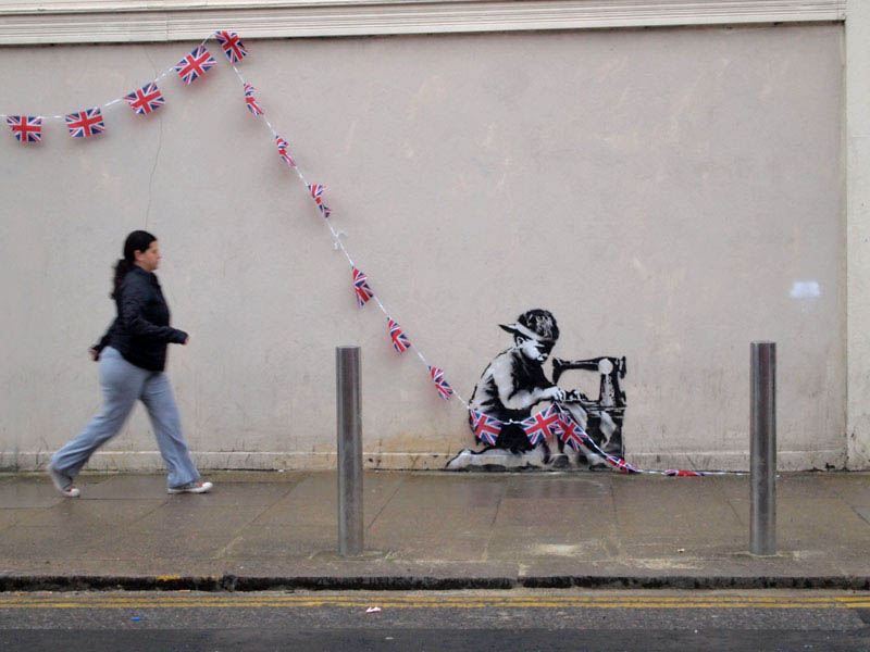 banksy boy sewing british flags street art stencil 1 10 Latest Artworks from Banksy