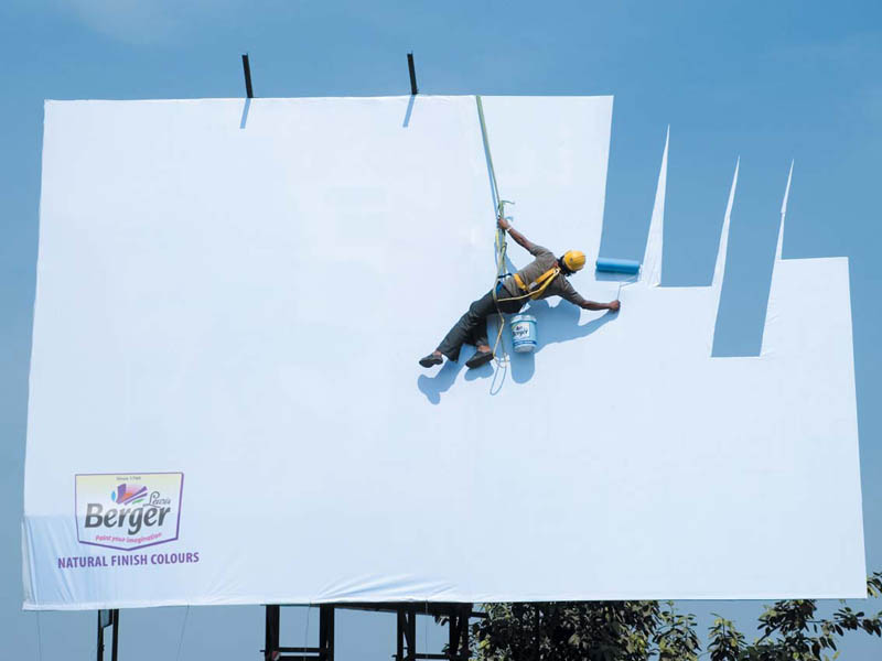 billboard with painter painting the sky 