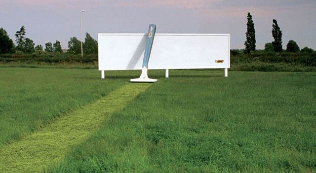 billboard for razors showing grass cut leading up to billboard and giant razor