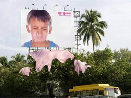 billboard for bubble gum shows gum all over trees from big bubble