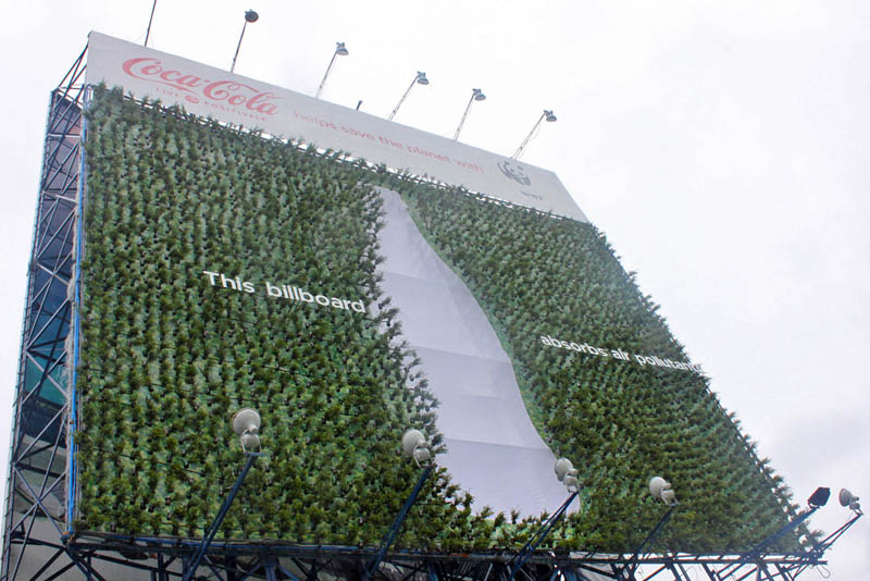 green billboard with plants to suck up carbon coca cola