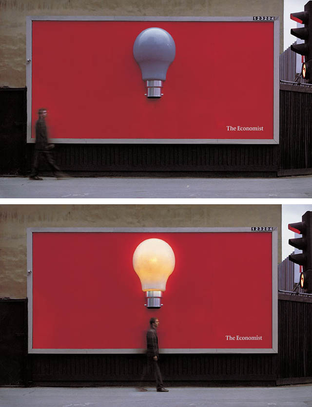 economist billboard with lightbulb that lights up when you walk past