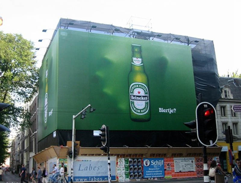 hand coming out of billboard to grab heineken bottle