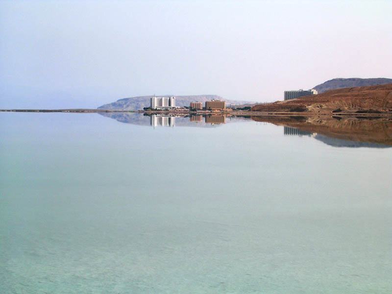 reflection of buildings on the shore of the dead sea