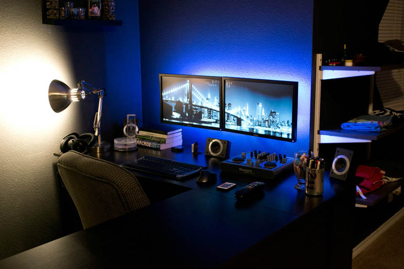 dual monitors mounted directly onto the wall with backlit blue led lights