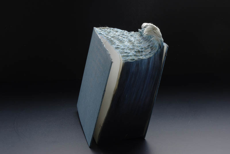 ocean wave carved into top of pages of book