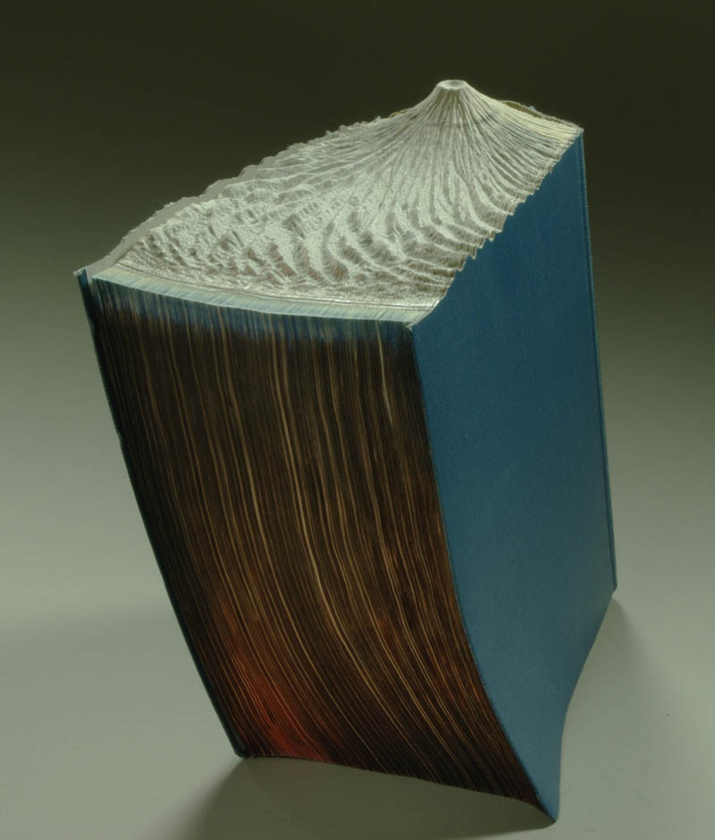 volcano carved into top of book pages