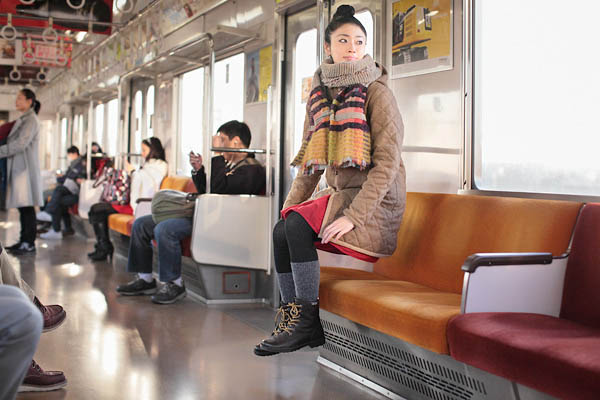 natsumi hayashi self portrait looks like she is levitating in subway car 