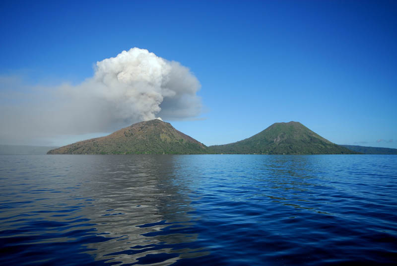 Mount Tavurvur of Rabaul caldera papa new guinea spewing ash with dormant volcano right beside
