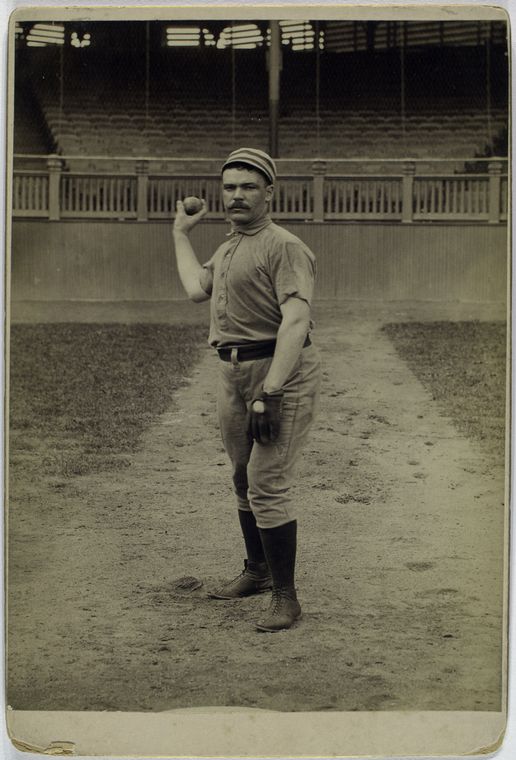 Deacon McGuire, Philadelphia Quakers posing for baseball photo about to throw a ball