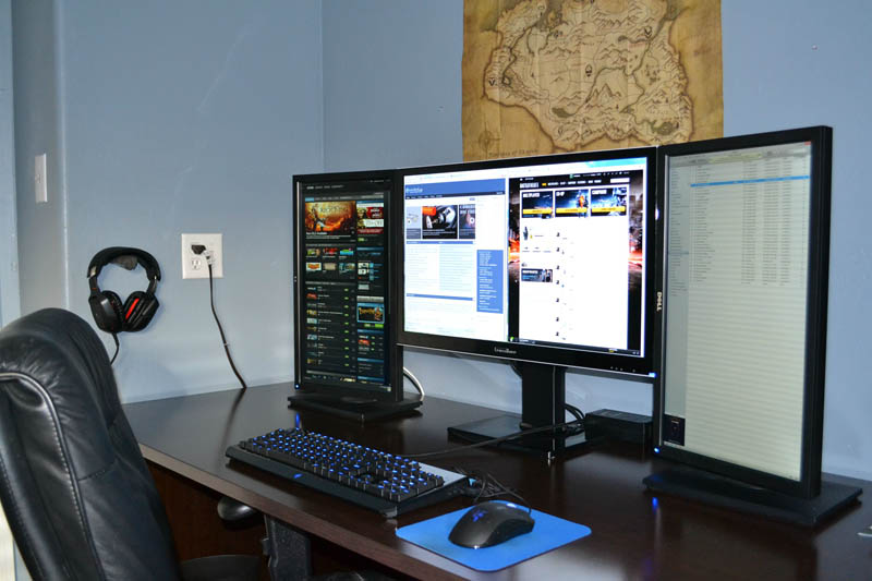 one large monitor in the middle flanked by two portrait style monitors on each side