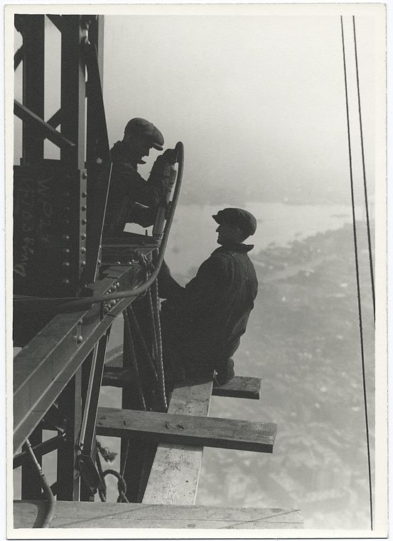 two workers riveting a corner beam of empire state building