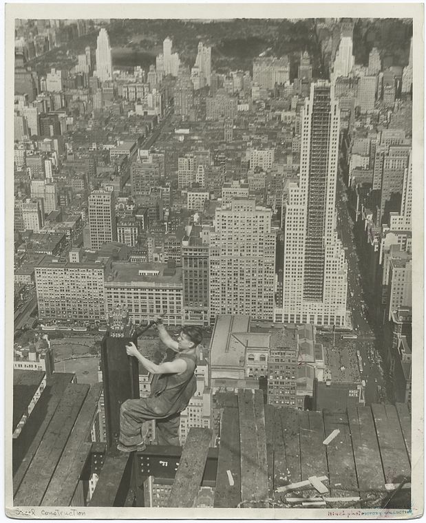 worker on edge of platform of empire state building 1931 new york city aerial clear in background