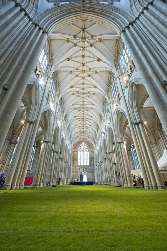 low angle shot of the york minster cathedral floor covered entirely in real grass