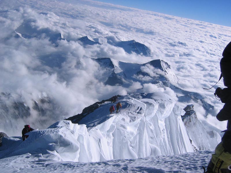 view from summit of other climbers approaching the summit