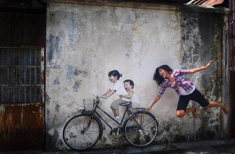 intearctive street art painted kids on wall riding real bike armenian street george town malaysia ernest zacharevic 8 How To Climb a 3 Story House Without Leaving the Ground