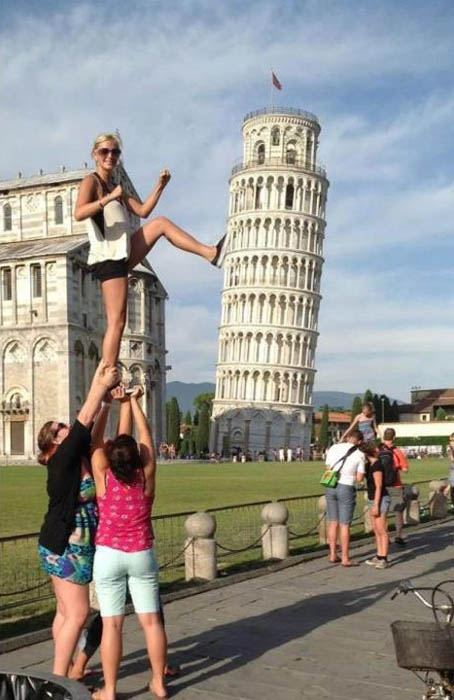 kicking the tower of pisa over and being held up by two friends to get higher