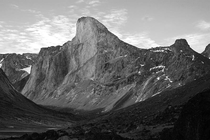 Mount thor or thor peak has the greatest purely vertical drop in the entire world. a wide angle shot of the mountain black and white