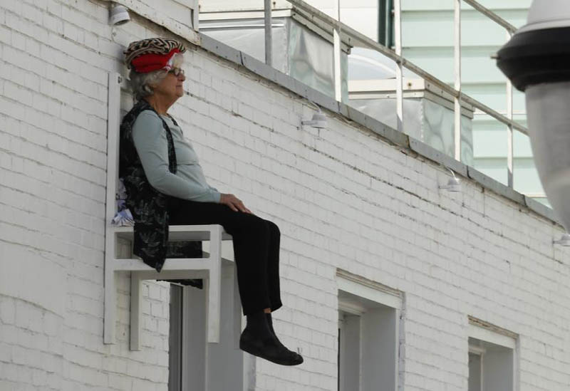 old people sitting in chairs high above ground in montreal angie heisl 10 Elderly People Suspended High Above the Streets of Montreal 