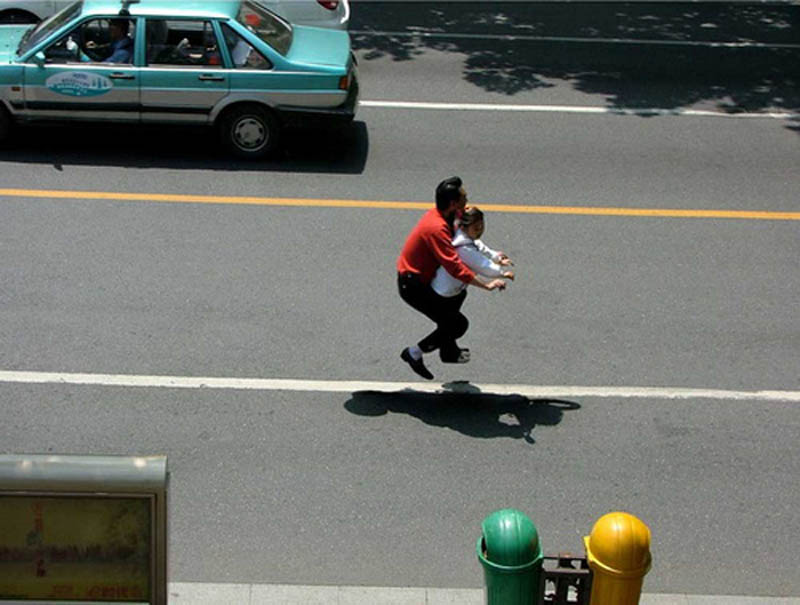 father and daughter riding an invisible bike on the road