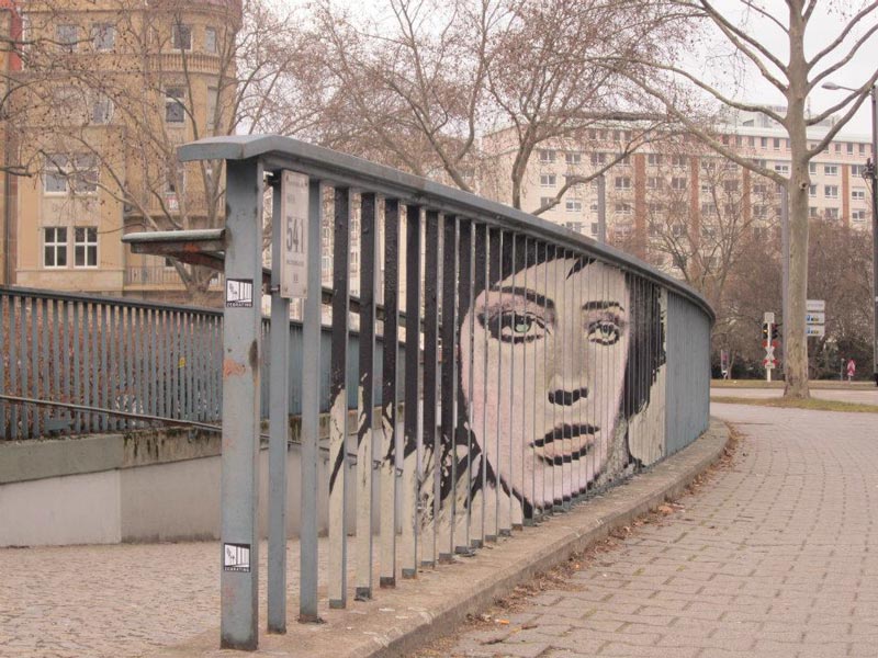 street art on railings by zebrating art 11 15 Street Art Portraits Chiseled Into Walls