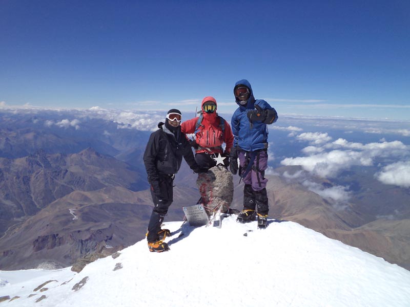 photo of three climbers at the summit of mount elbrus