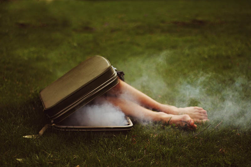 kyle thompsons feet coming out of a smoking briefcase surreal self portrait