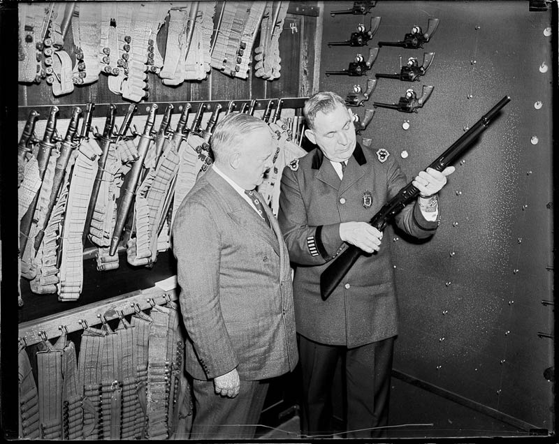 police commissioner and superintendent at police headquarters checking out weapons