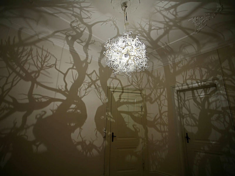 chandelier projects shadow forest on walls hilden and diaz (1)