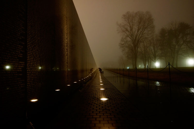 man crouched at vietnam memorial washington The Top 100 Pictures of the Day for 2013