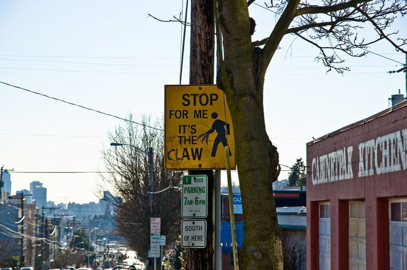 it's the claw funny street sign