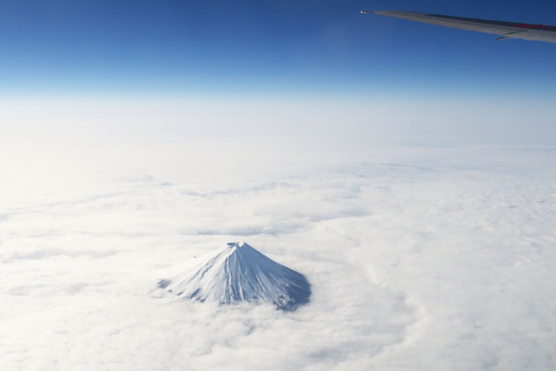 mount fuji from an airplane above the clouds