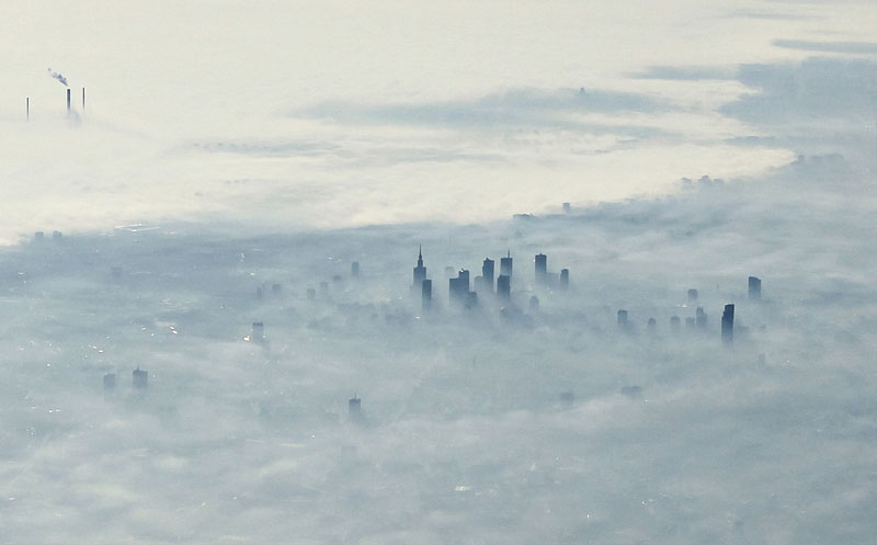 warsaw poland covered in fog from an airplane aerifal from above