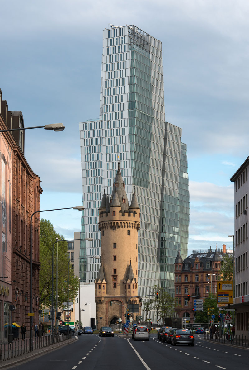 old tower in front of modern high rise frankfurt germany (1)