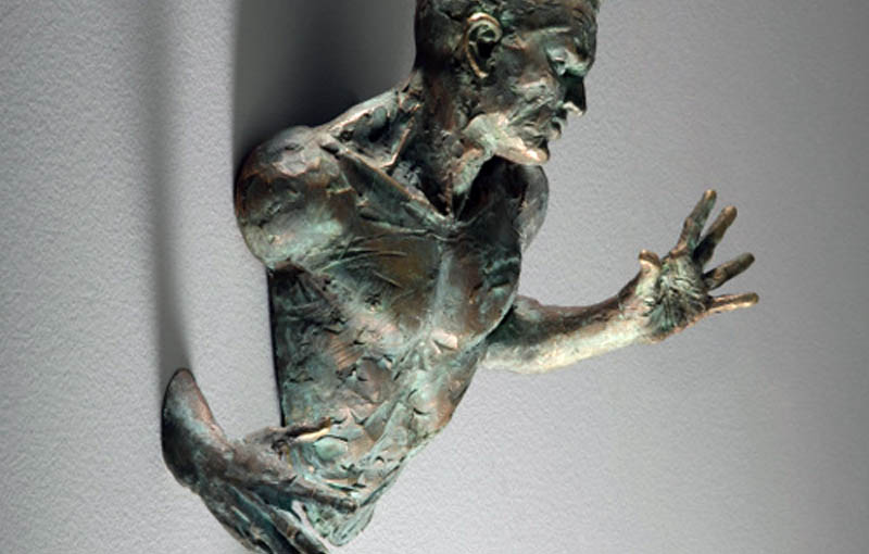 Amazing Sculptures That Emerge from Walls