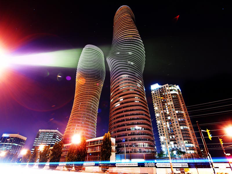 night shot of the marilyn monroe absolute towers in mississauga by mad architects
