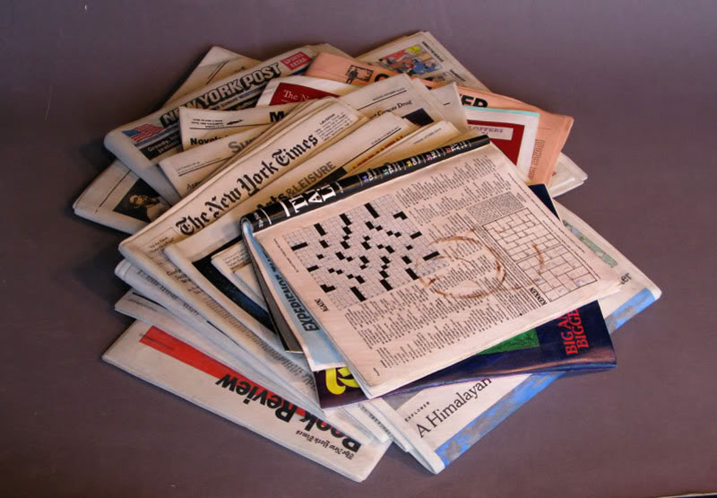 A Block of Wood Carved Into a Stack of Papers and Magazines