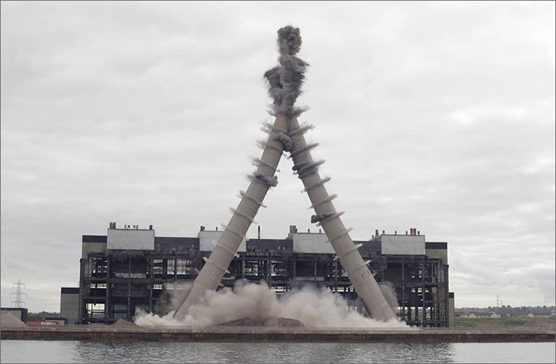 Controlled Demolition Makes Two 500 ft Chimneys Perfectly Collide and Crumble